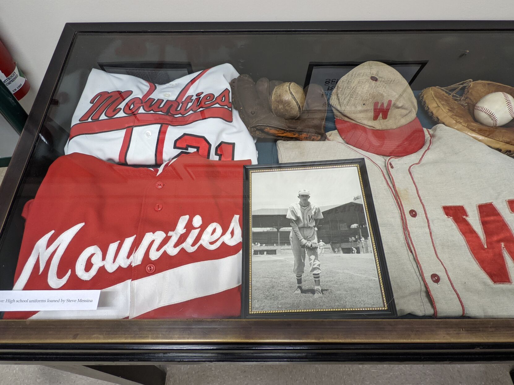 display case shows high school uniforms